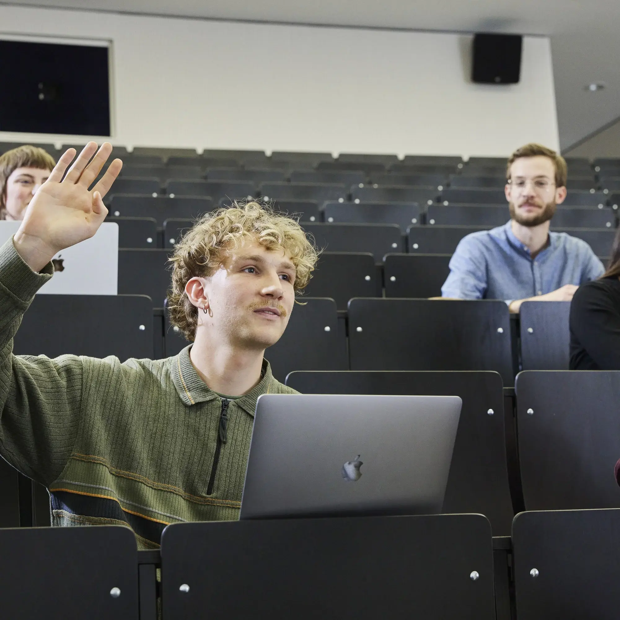 A student raises his hand during a lecture.