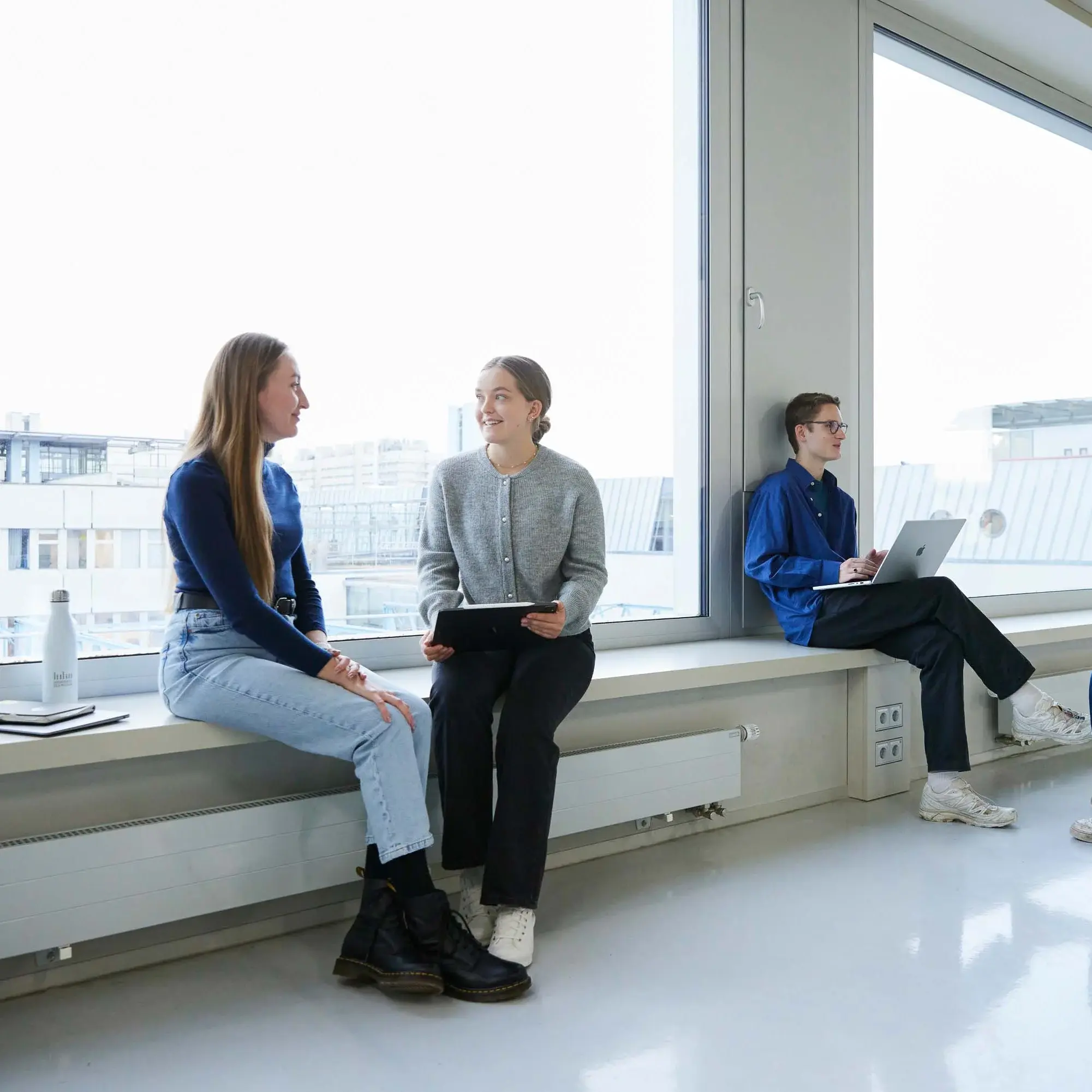 Students chat in small groups.