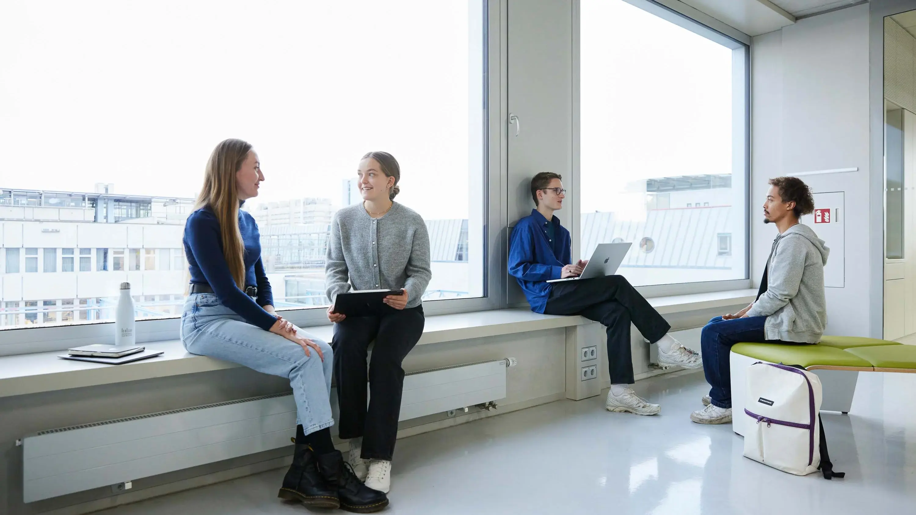 Students chat in small groups.