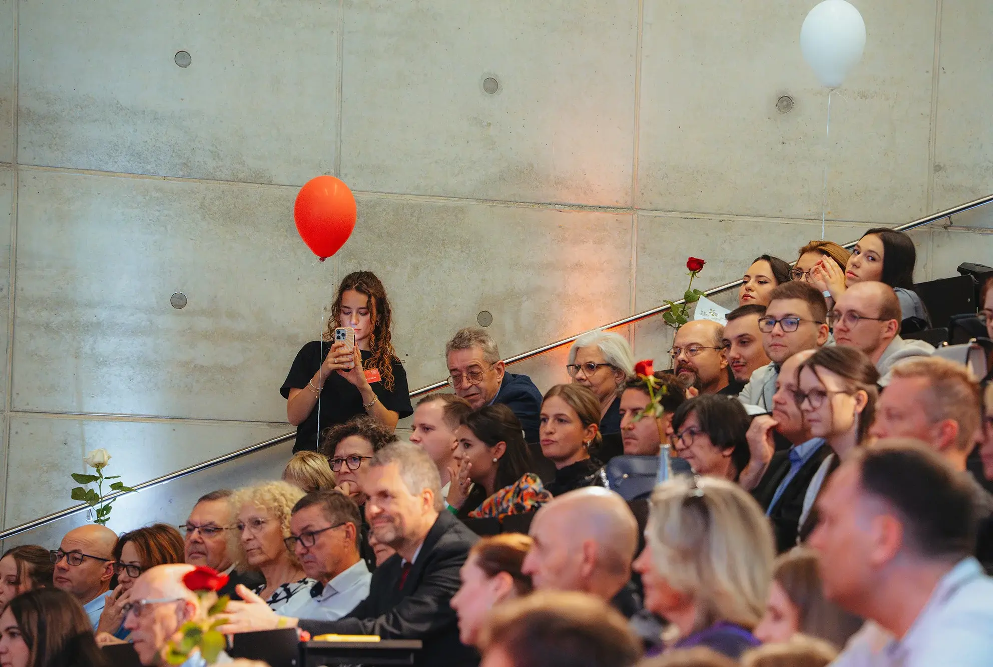 Graduates and audience in the lecture hall