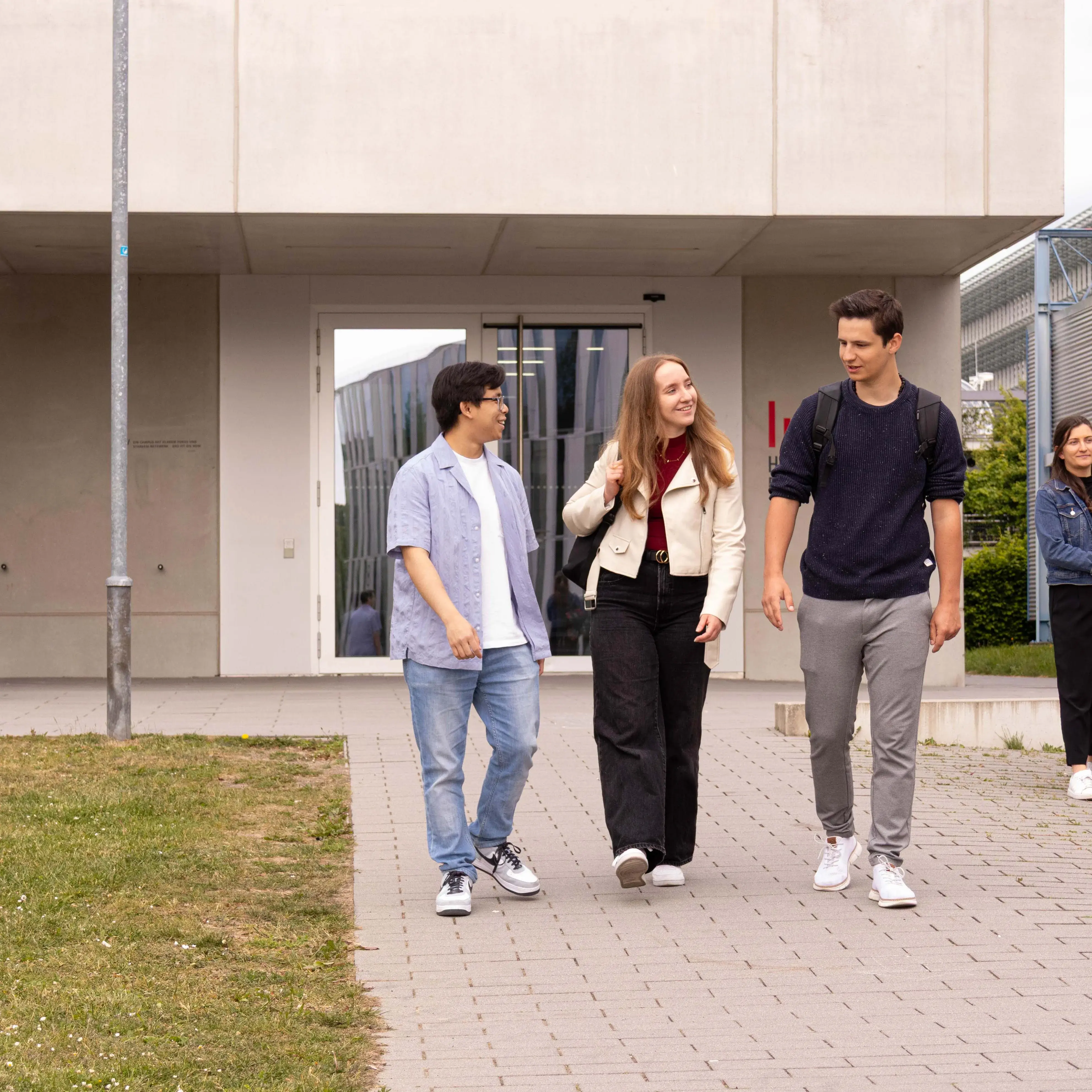Students chat as they leave the Hochschule der Medien.