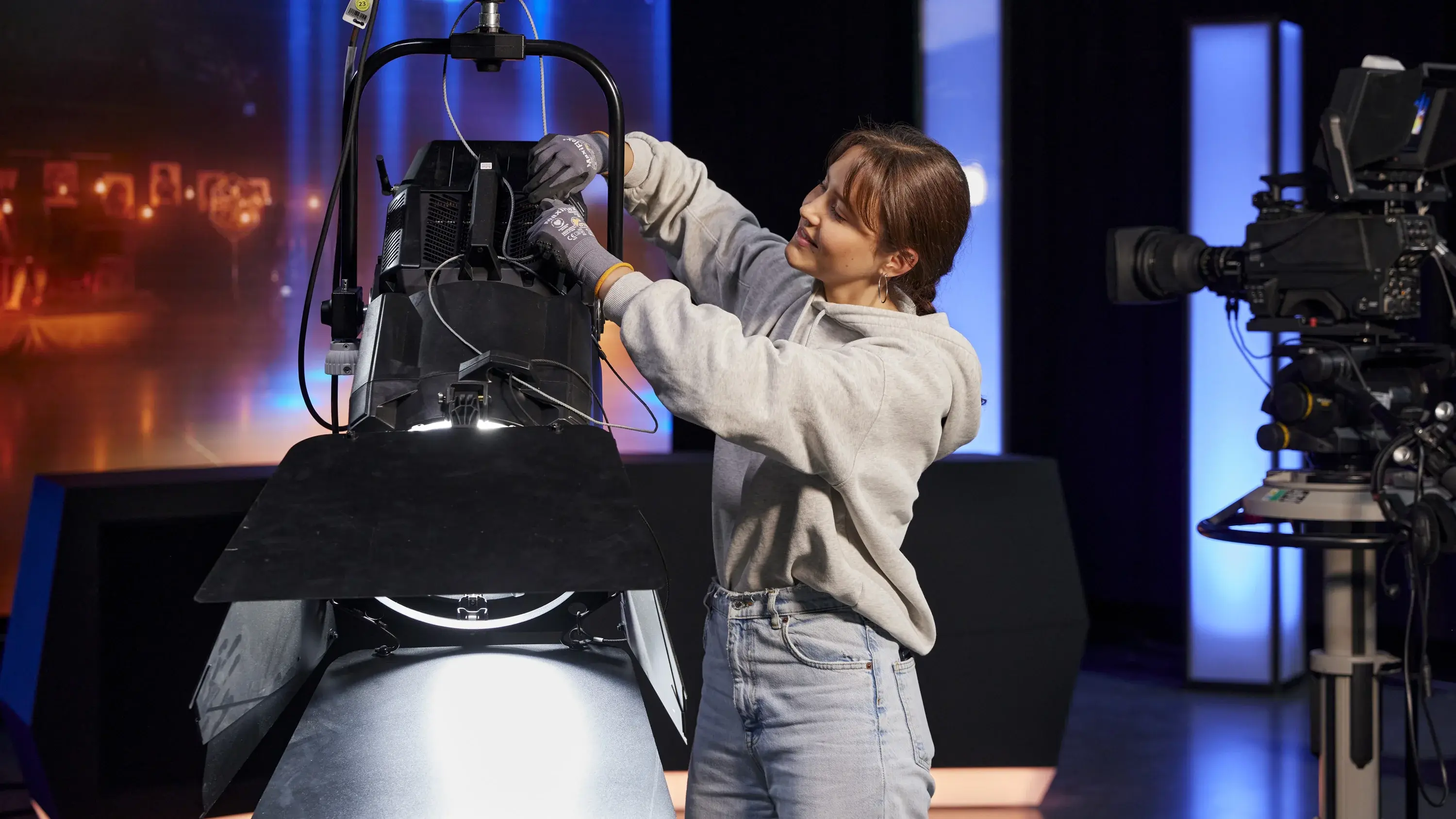 A student works on the technology in the television studio at the Hochschule der Medien.