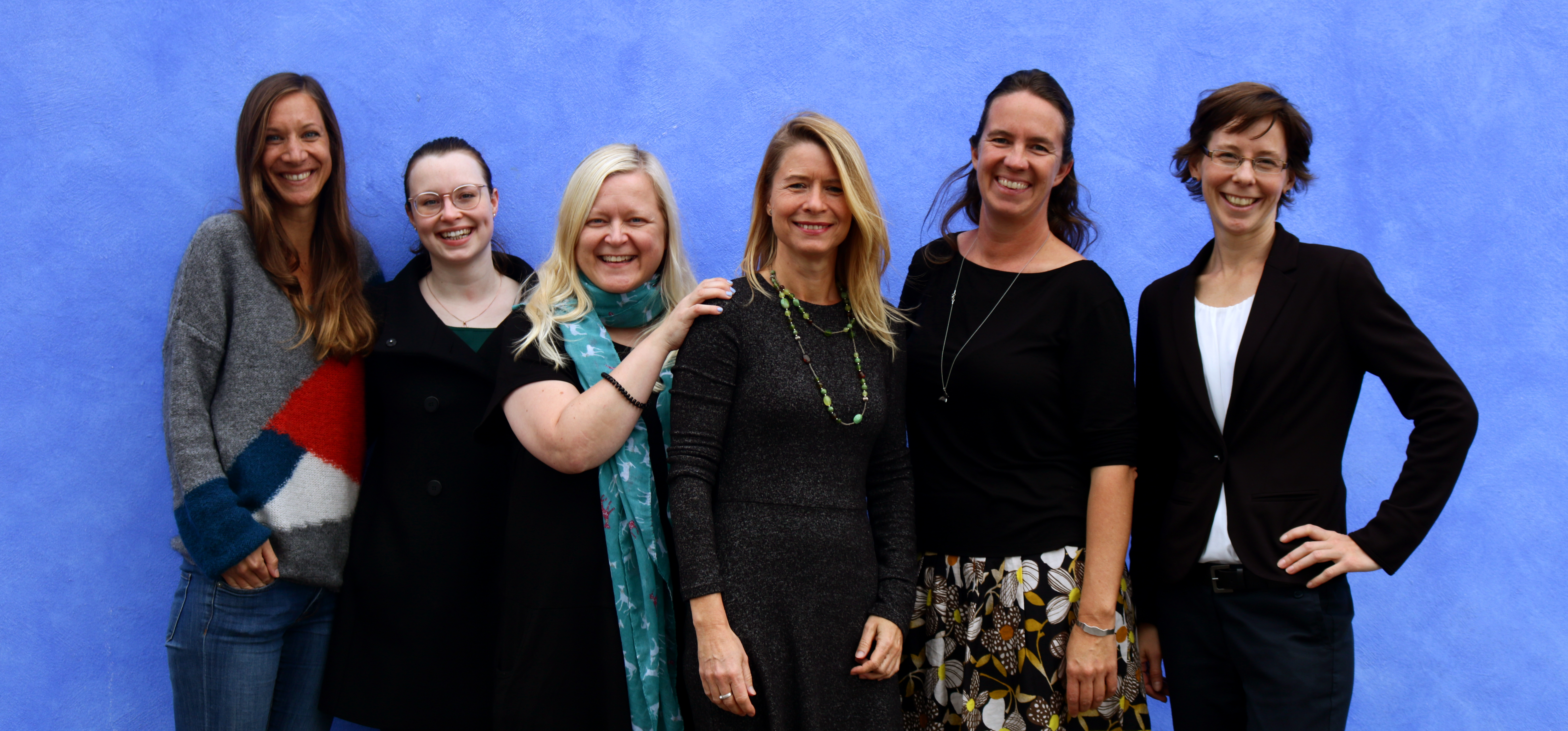 The entire International Office staff smiling at you